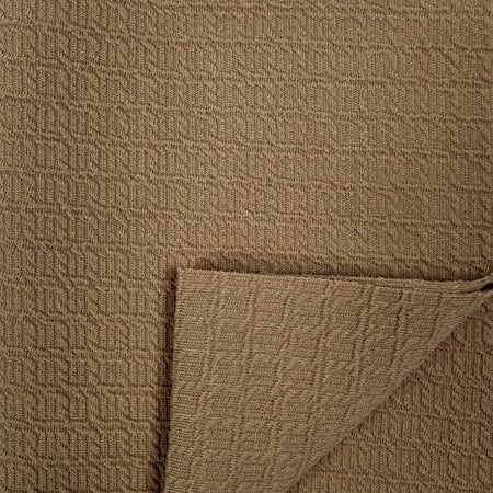 Close-up of brown textured fabric with a corner folded over
