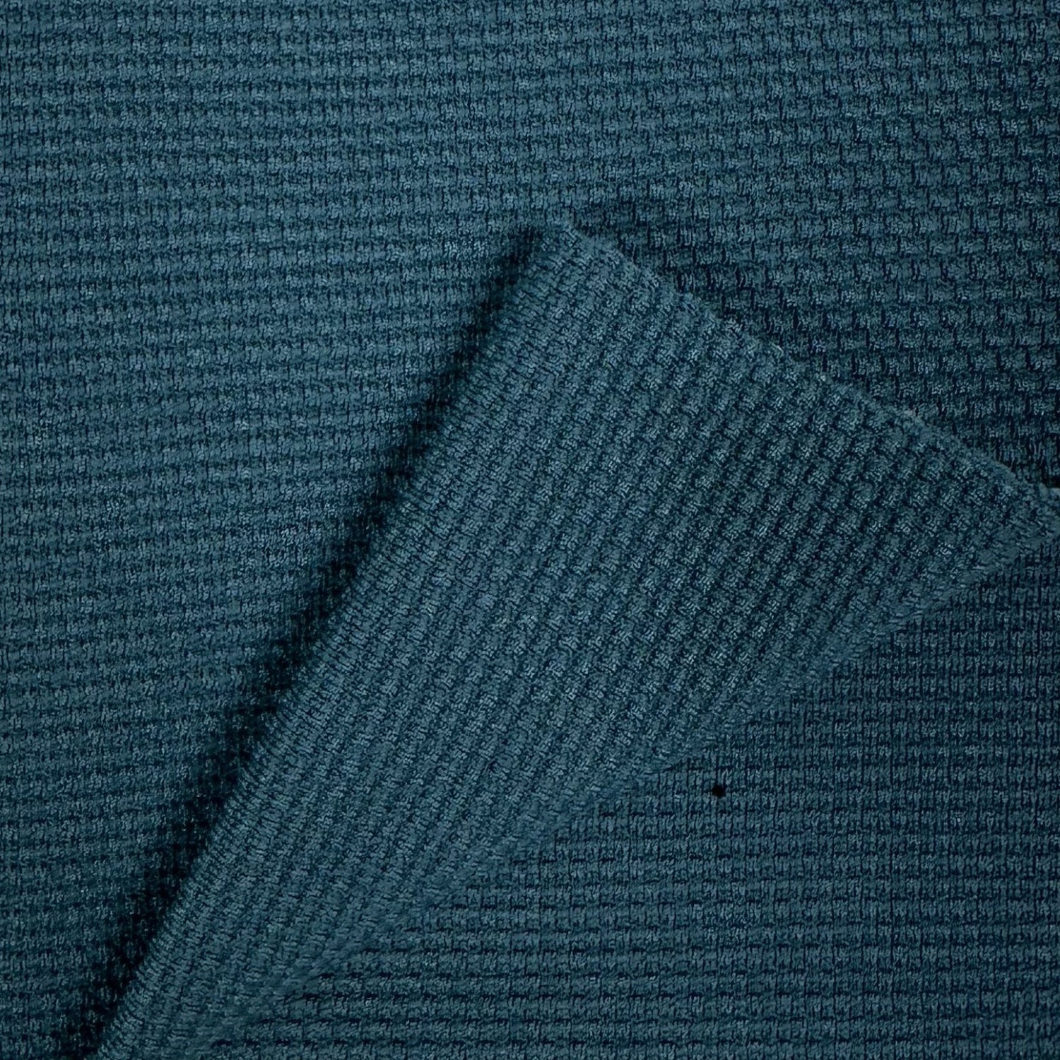 Close-up of textured blue fabric with a diagonal pattern