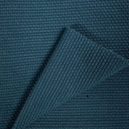 Close-up of textured blue fabric with a diagonal pattern