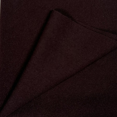 Close-up of dark brown fabric with a diagonal fold