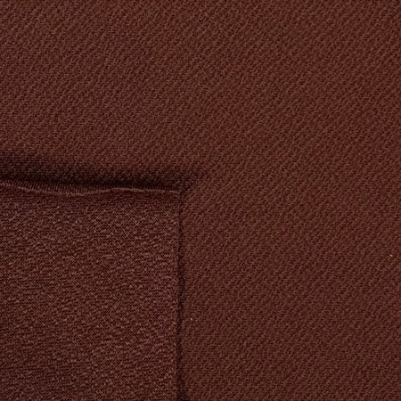 Close-up of brown fabric with a subtle pattern