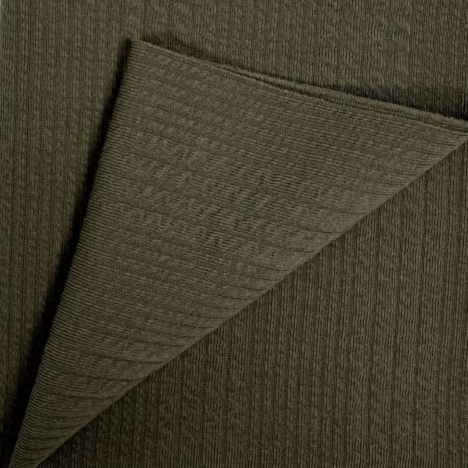 Close-up of dark green fabric with a diagonal fold