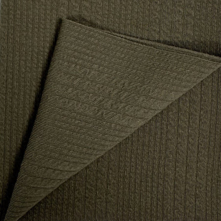 Close-up of dark green fabric with a diagonal fold