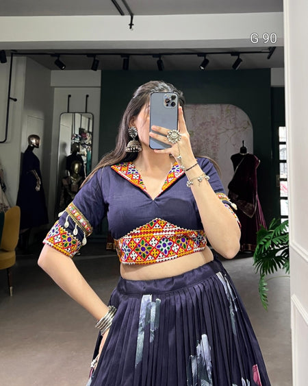 Person wearing a colorful traditional outfit in a mirror selfie.