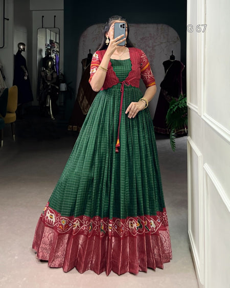 Person wearing a green and red traditional outfit taking a mirror selfie.