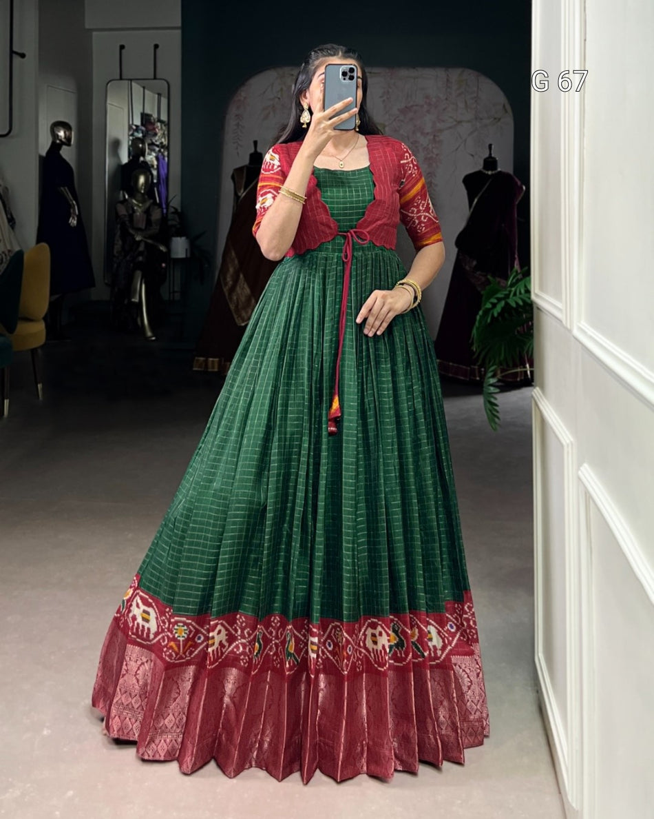 Person wearing a green and red traditional outfit taking a mirror selfie.