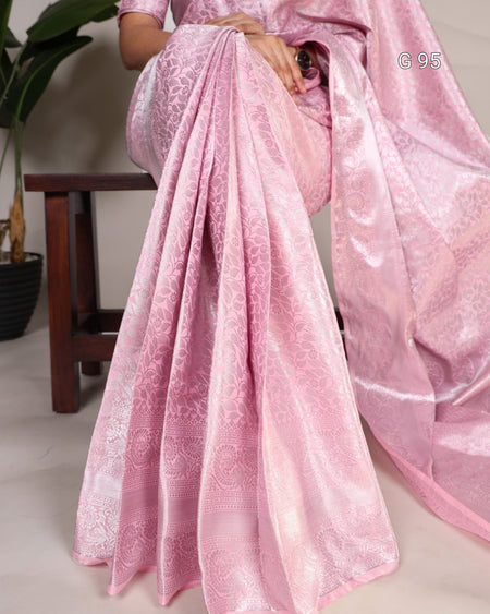 Pink saree with a subtle pattern draped over a chair