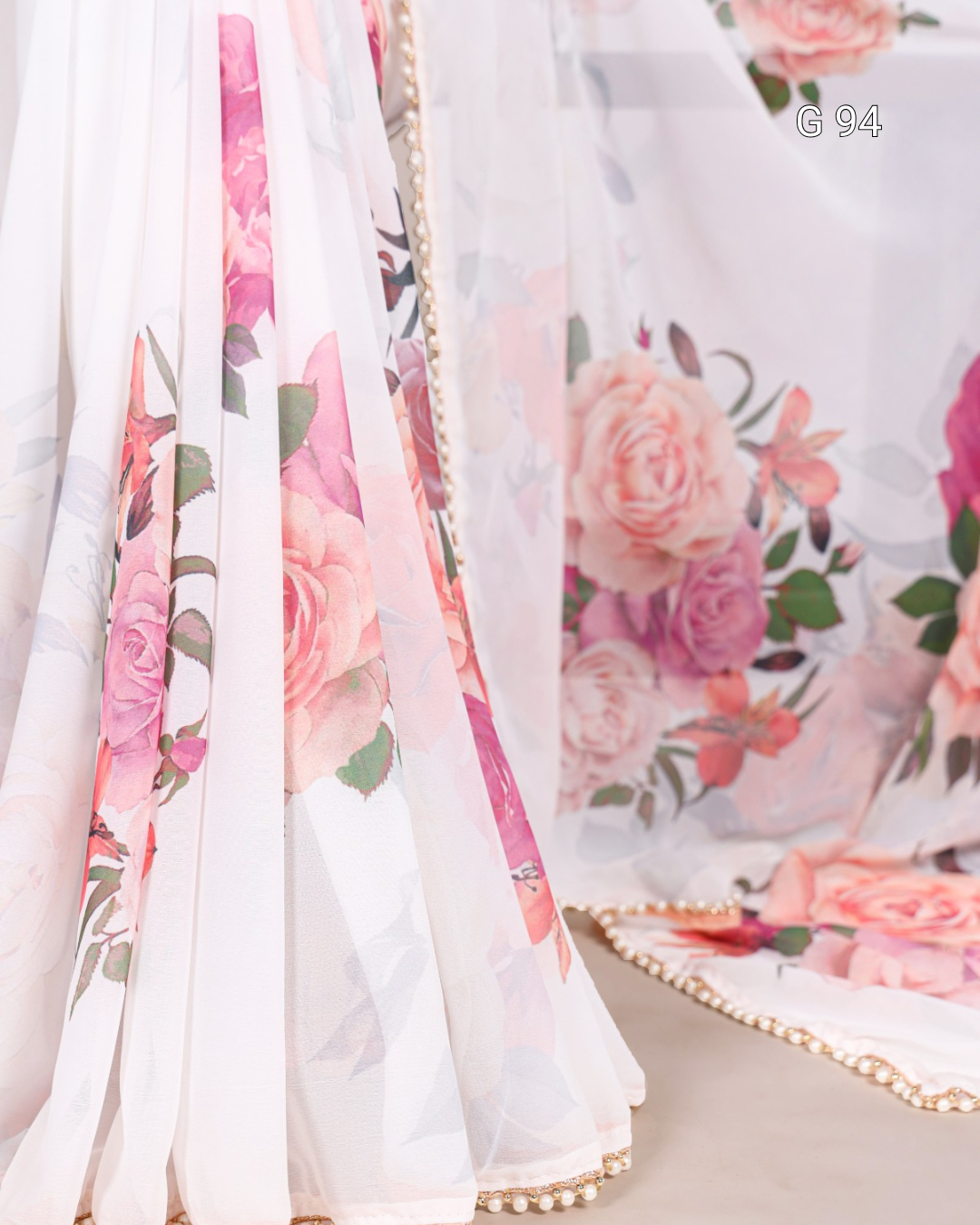 Floral fabric with pink and green flowers on a white background