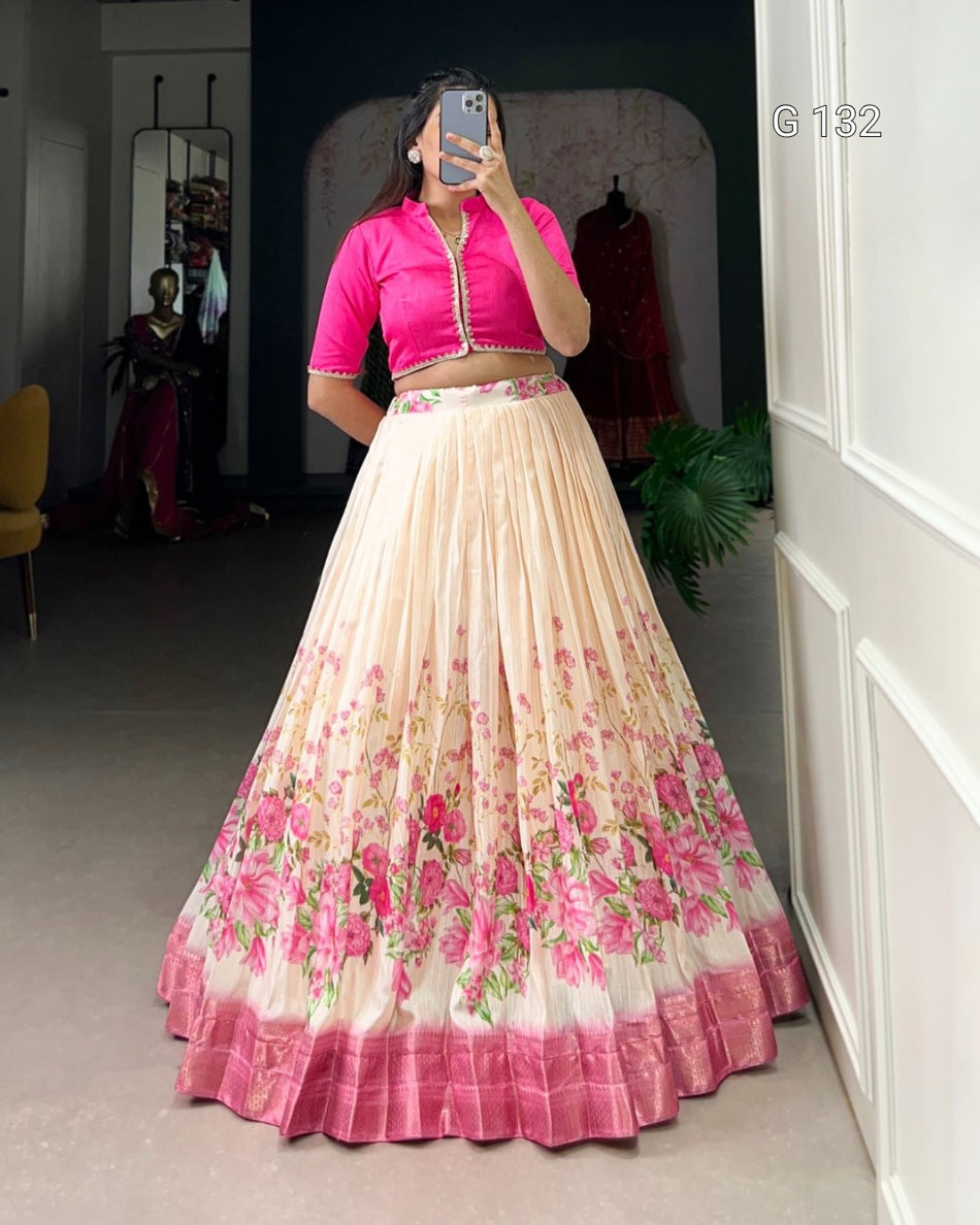 Woman wearing a pink blouse and floral skirt in a room with a mirror.