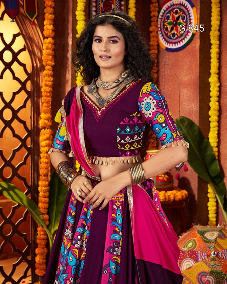 Woman in a colorful traditional outfit with a decorative background