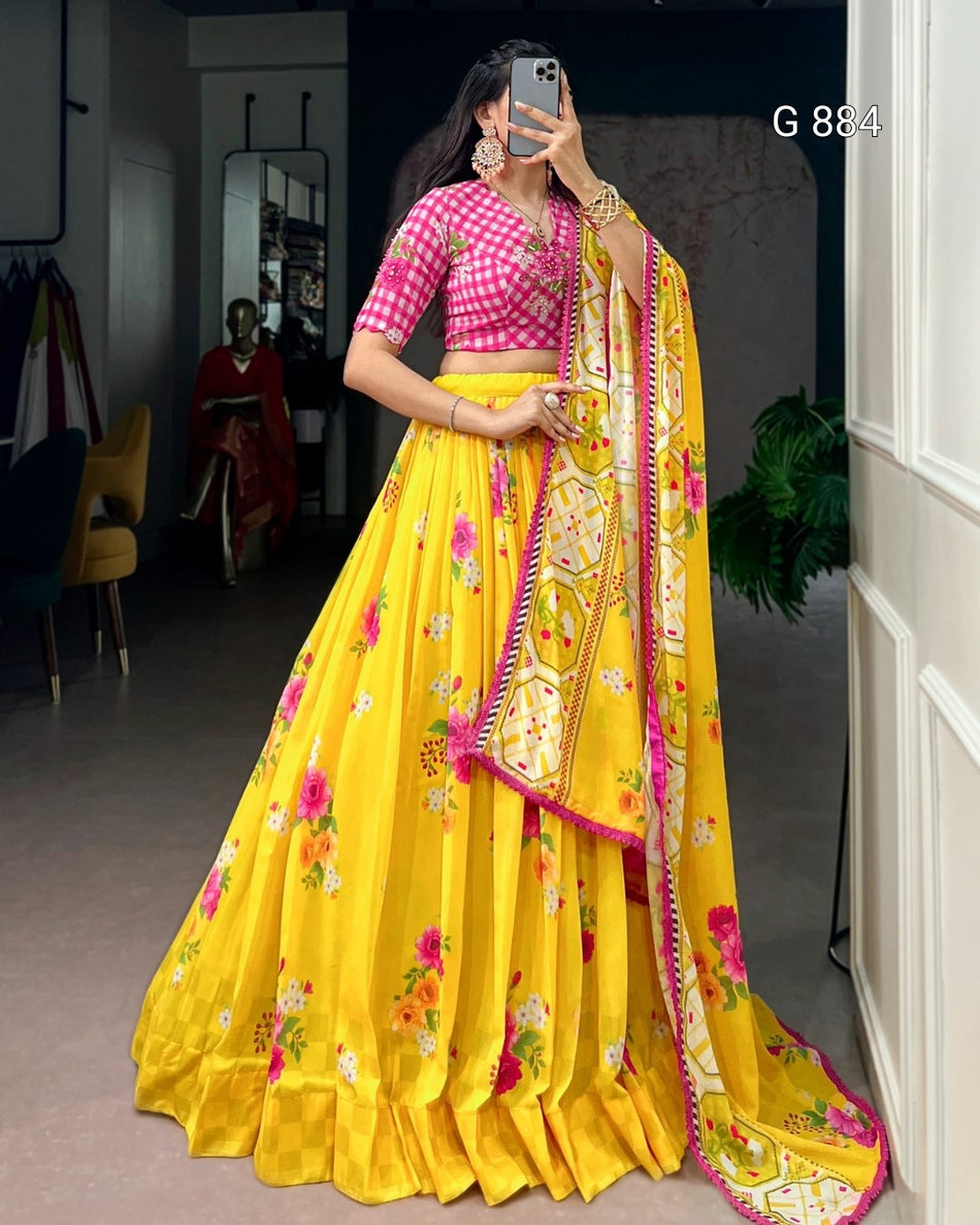 Woman wearing a yellow saree with pink blouse in a room setting