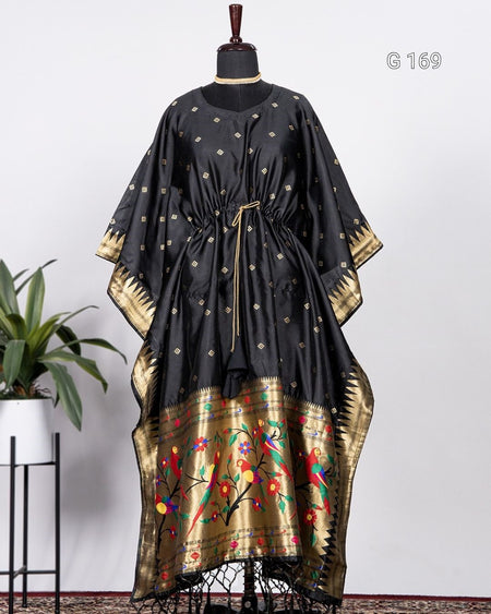 Black and gold traditional dress on a mannequin with a white background