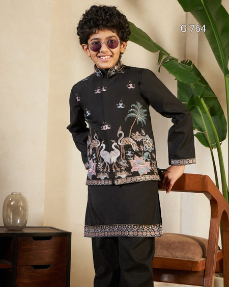 Child wearing a black embroidered traditional outfit with sunglasses, standing indoors.