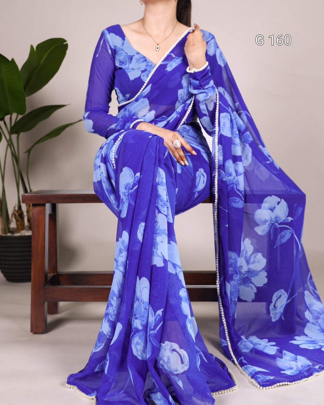 Blue floral saree with a plain background