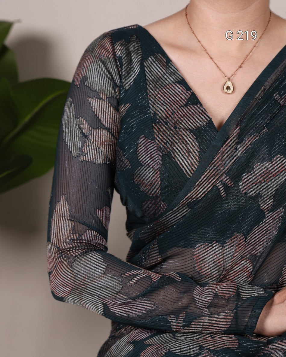 Close-up of a person wearing a dark floral patterned dress with a blurred background