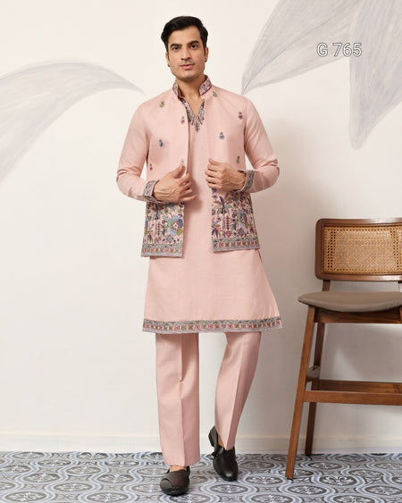 Man wearing a traditional pink kurta set with a chair in the background