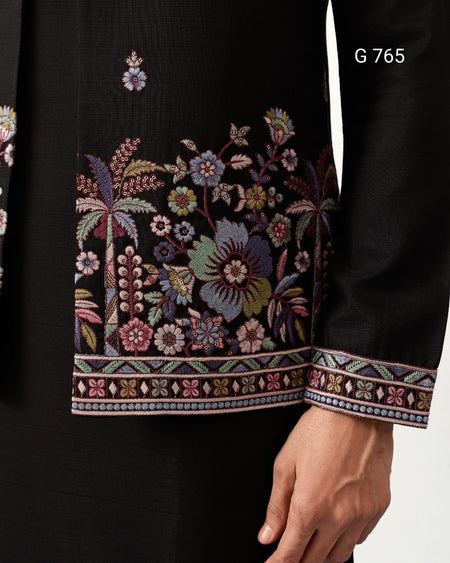 Black garment with intricate floral embroidery on a plain background