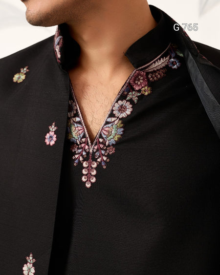 Black shirt with floral embroidery on a white background