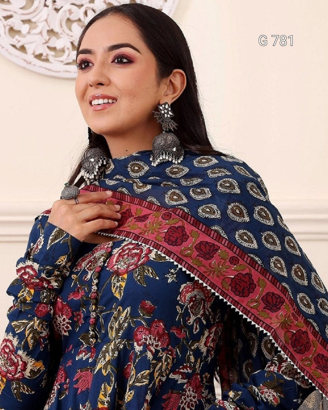 Woman wearing a traditional embroidered garment with floral patterns