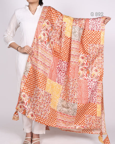 Person holding a colorful patterned scarf against a white background
