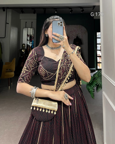 Person wearing a traditional outfit with a matching handbag in an indoor setting.