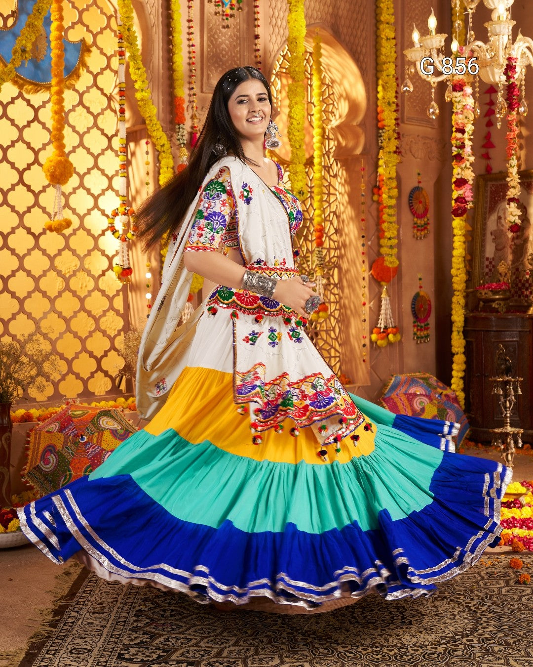 Woman in a colorful traditional outfit with a decorated background