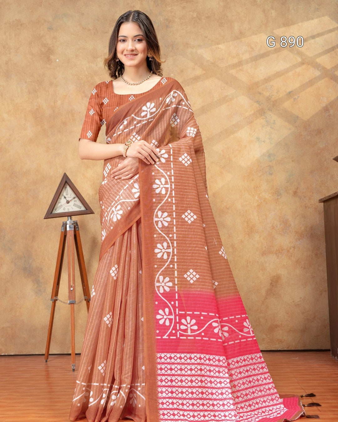 Woman wearing a traditional saree with a geometric pattern against a brown background