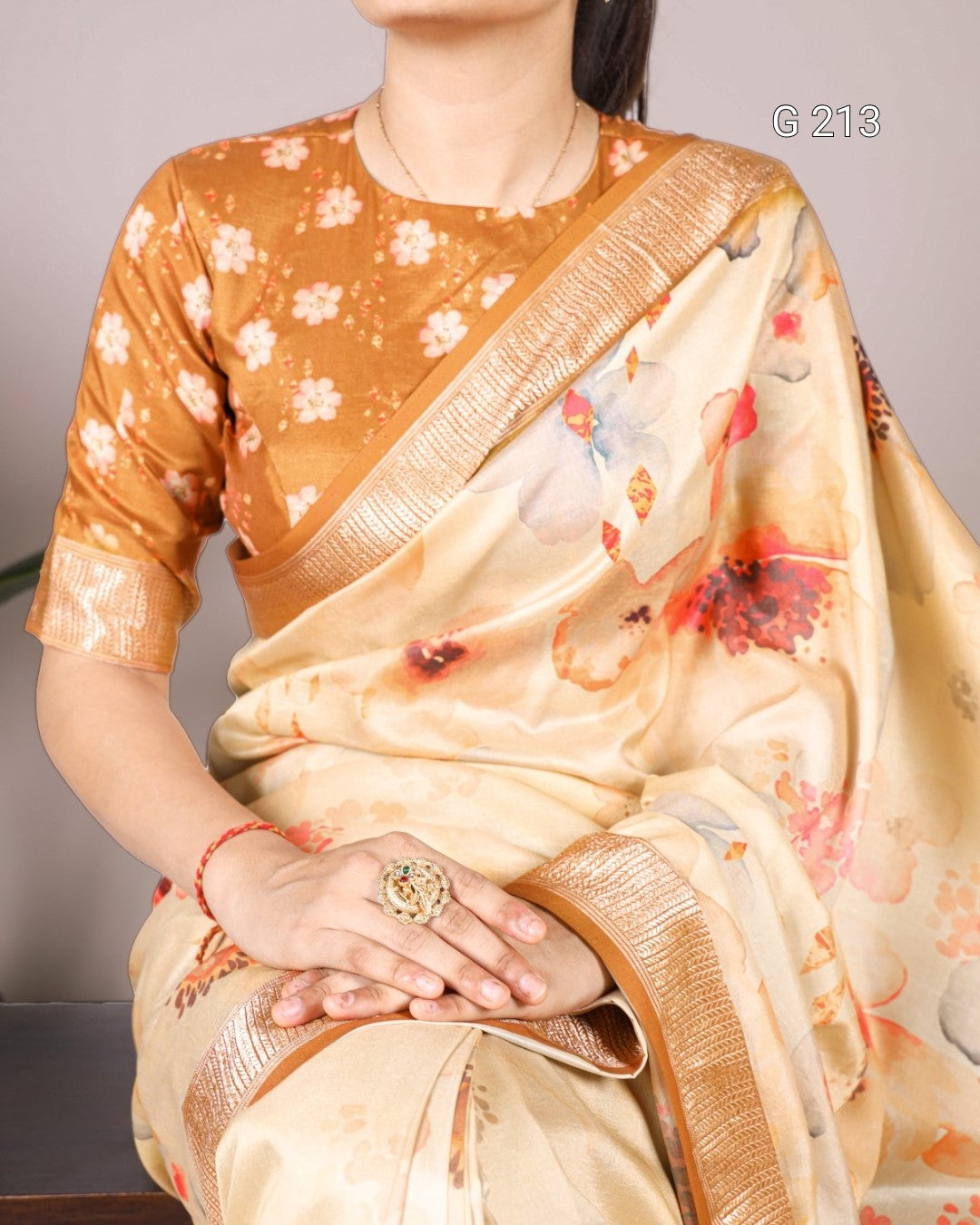 Woman wearing a floral saree with a plain background