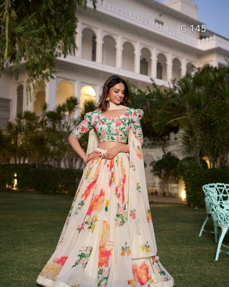 Woman in a floral outfit standing in front of a building with greenery