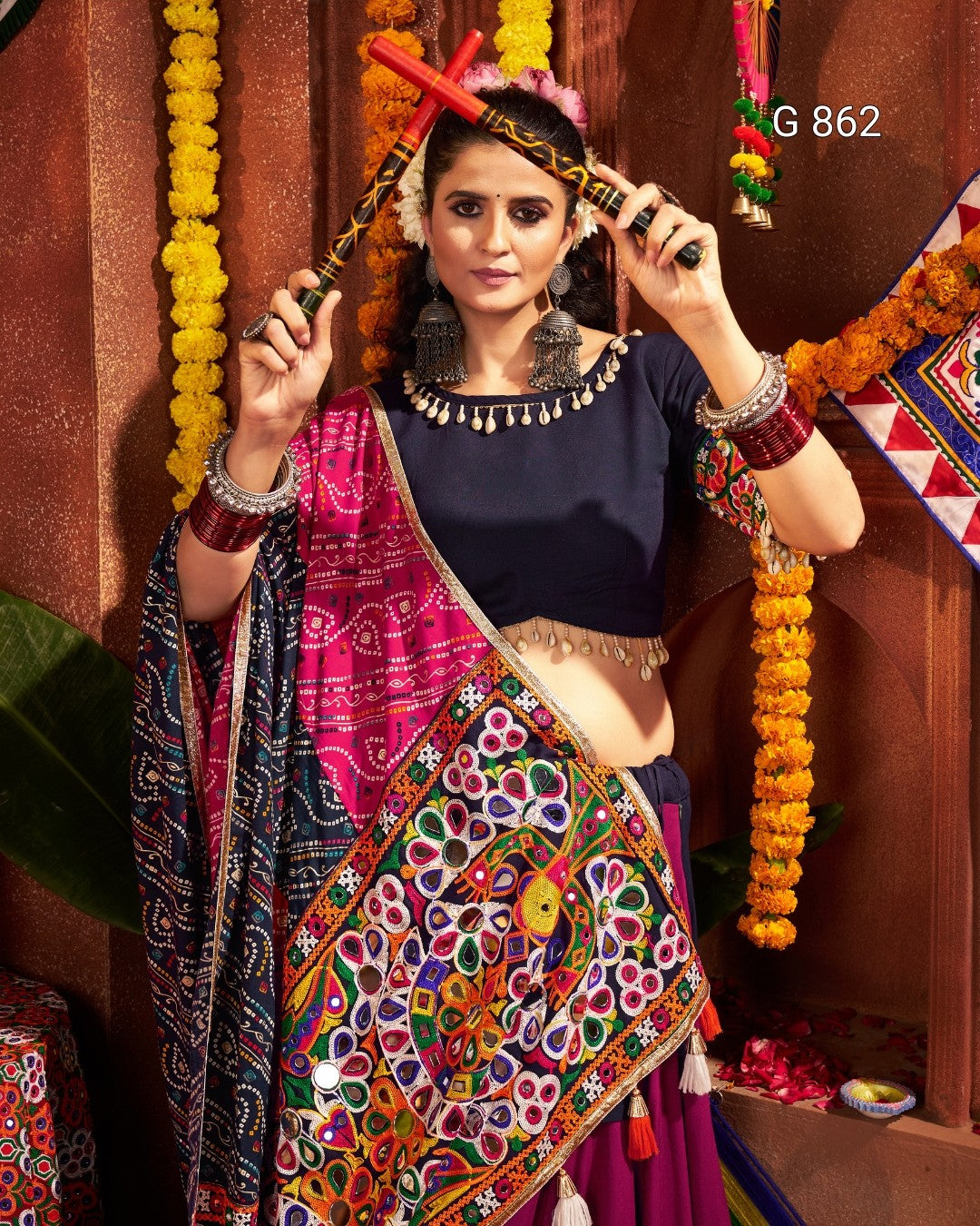 Woman in traditional attire with colorful decorations and jewelry