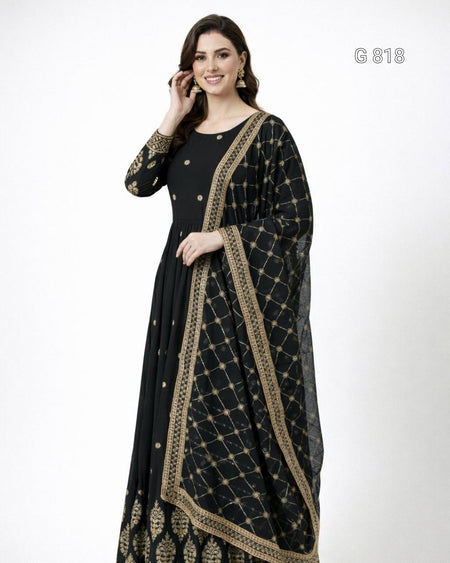 Woman wearing a black and gold patterned dress on a white background