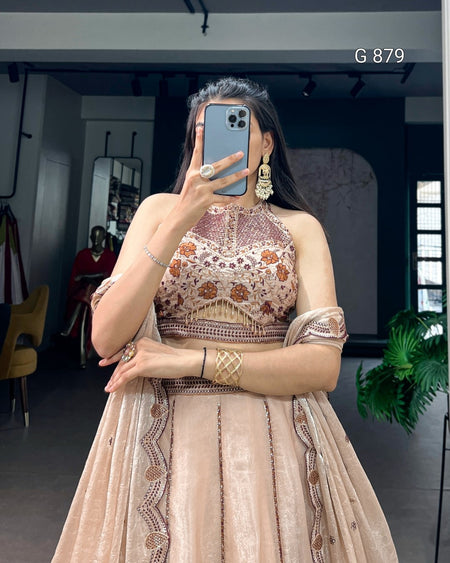 Woman taking a mirror selfie wearing an embroidered traditional outfit in a room.