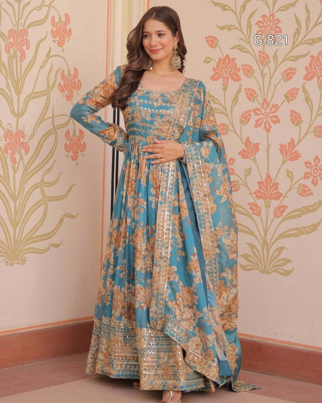 Woman wearing a floral dress with a decorative wall in the background