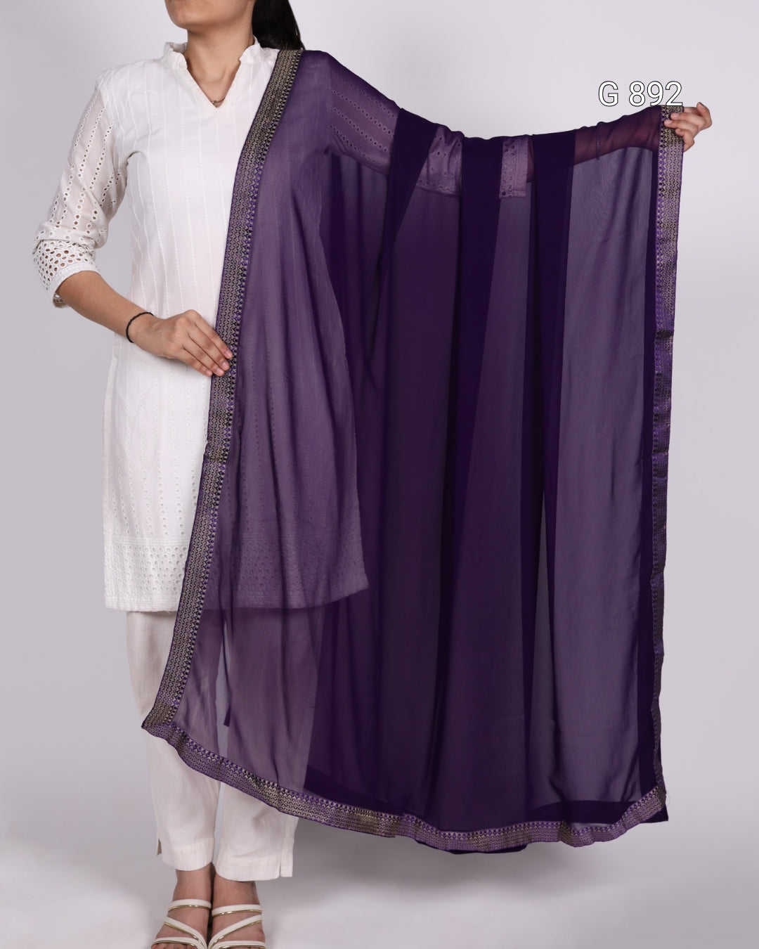 Person holding a purple scarf with a white background