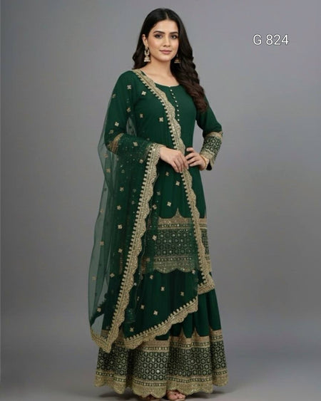 Woman wearing a green traditional outfit with gold embroidery on a gray background