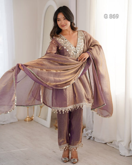 Woman wearing a traditional outfit with a shawl in a well-lit room.