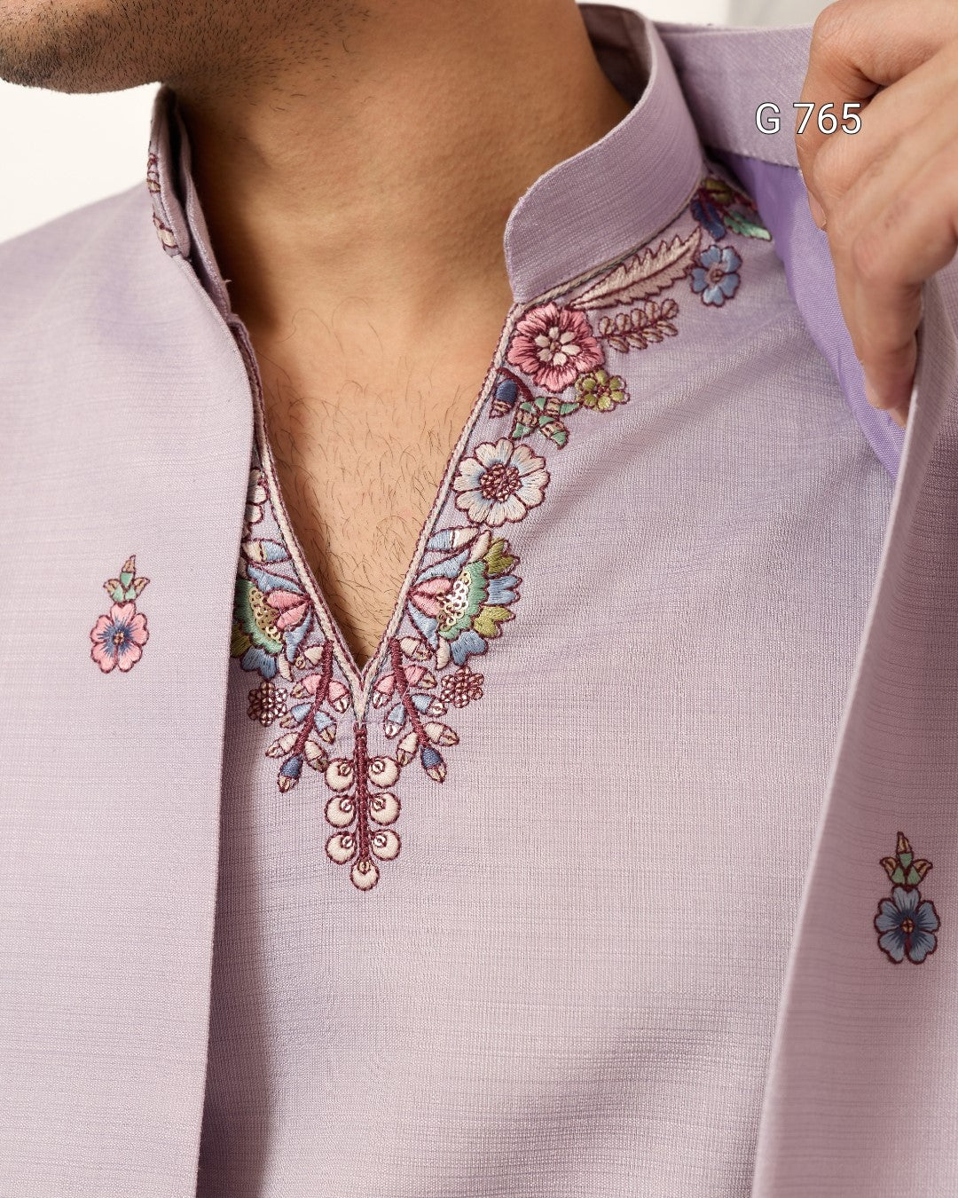 Close-up of a light purple shirt with floral embroidery details.