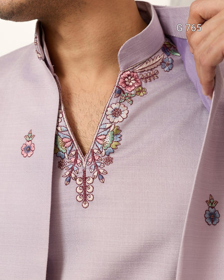 Close-up of a light purple shirt with floral embroidery details.