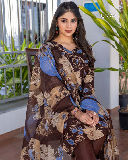 Woman wearing a brown and blue floral patterned outfit sitting outdoors.