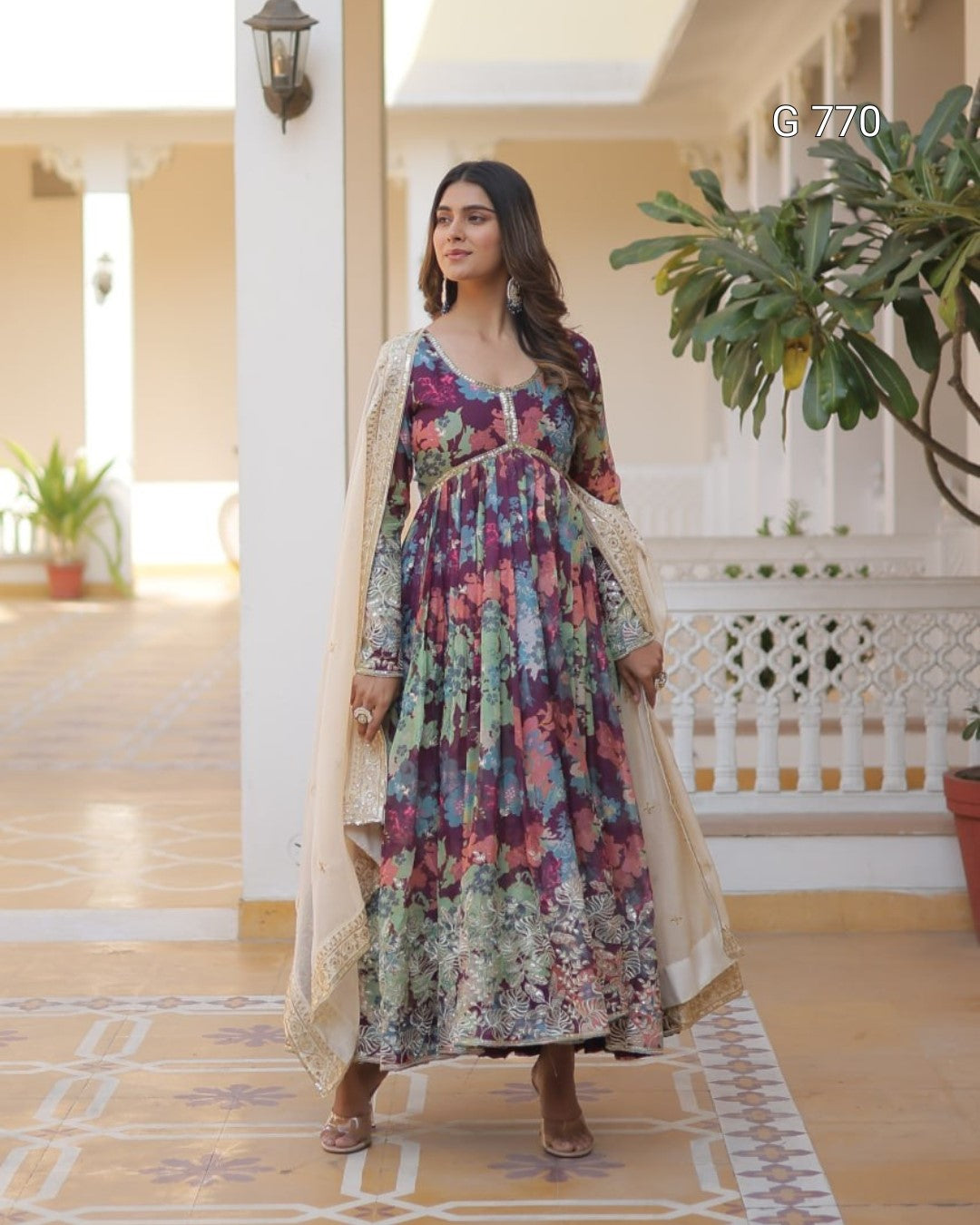 Woman in a floral dress standing in a decorated indoor setting