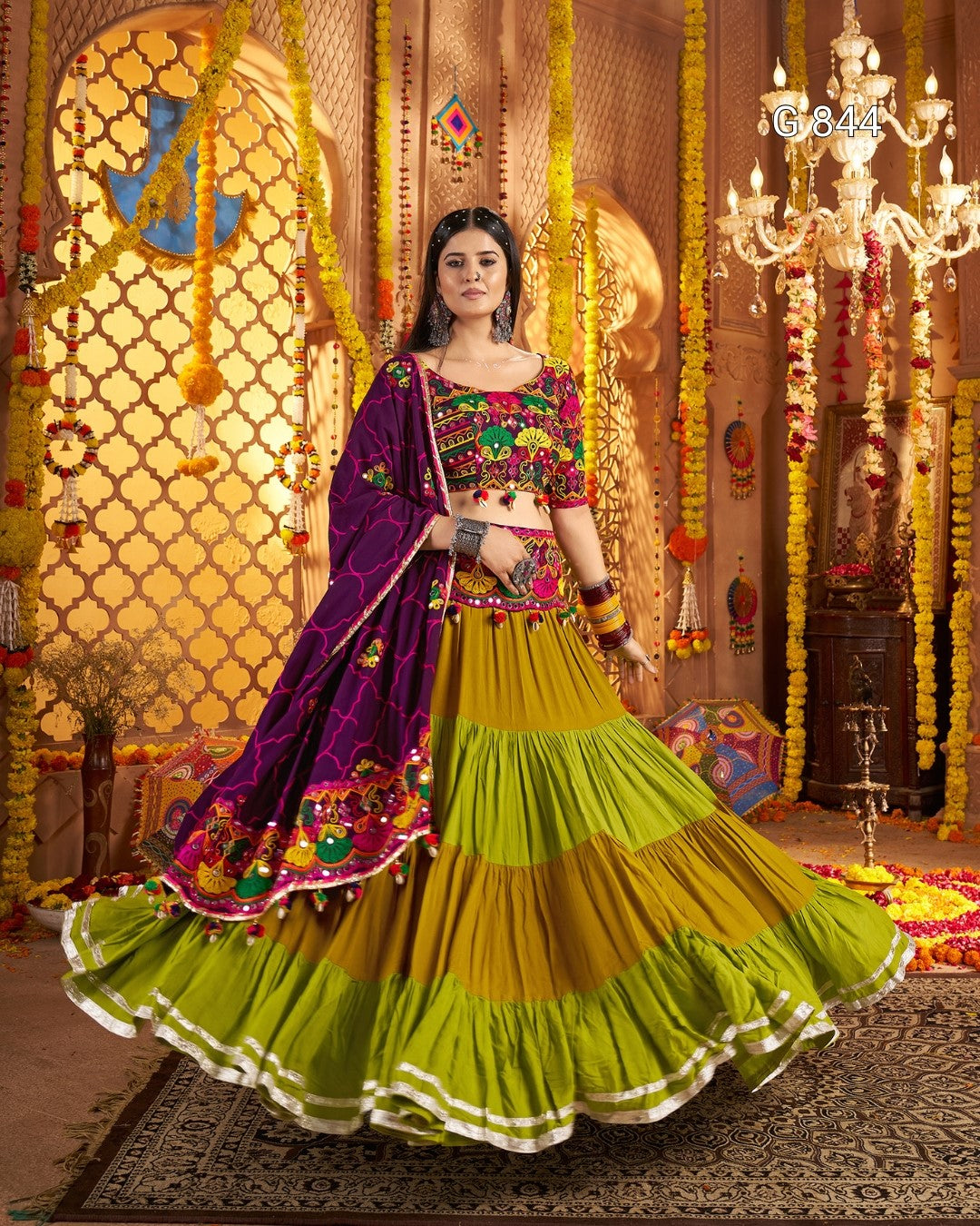 Woman in a colorful traditional outfit with a richly decorated background
