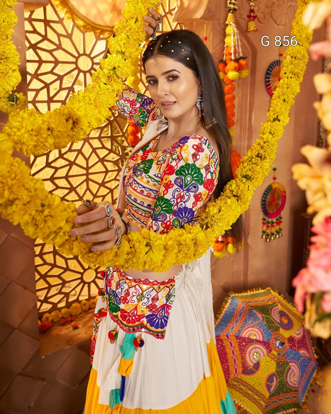 Woman in traditional colorful outfit with floral decorations, G 856 visible
