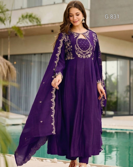 Woman wearing a purple embroidered dress by a poolside