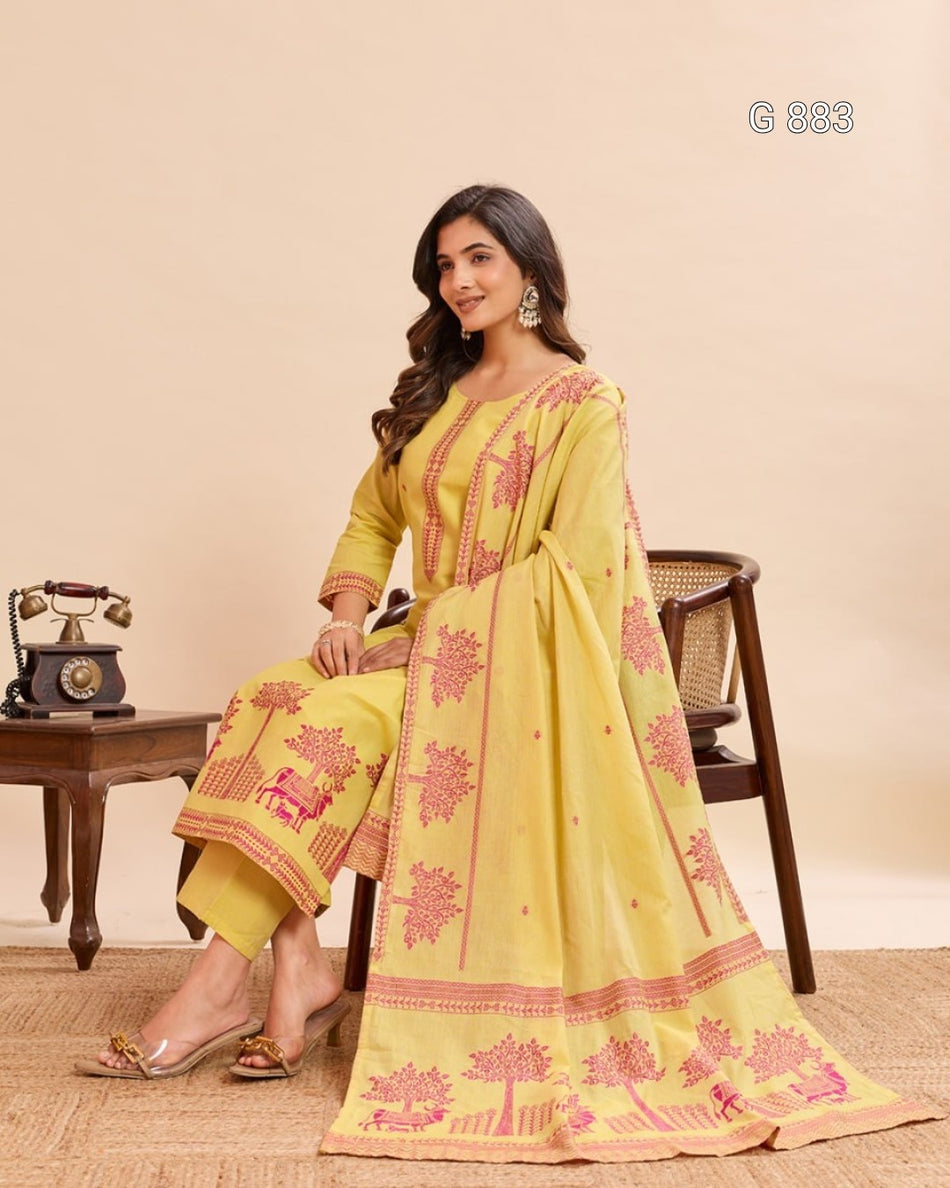 Woman wearing a yellow and pink traditional outfit sitting on a chair with a beige background.