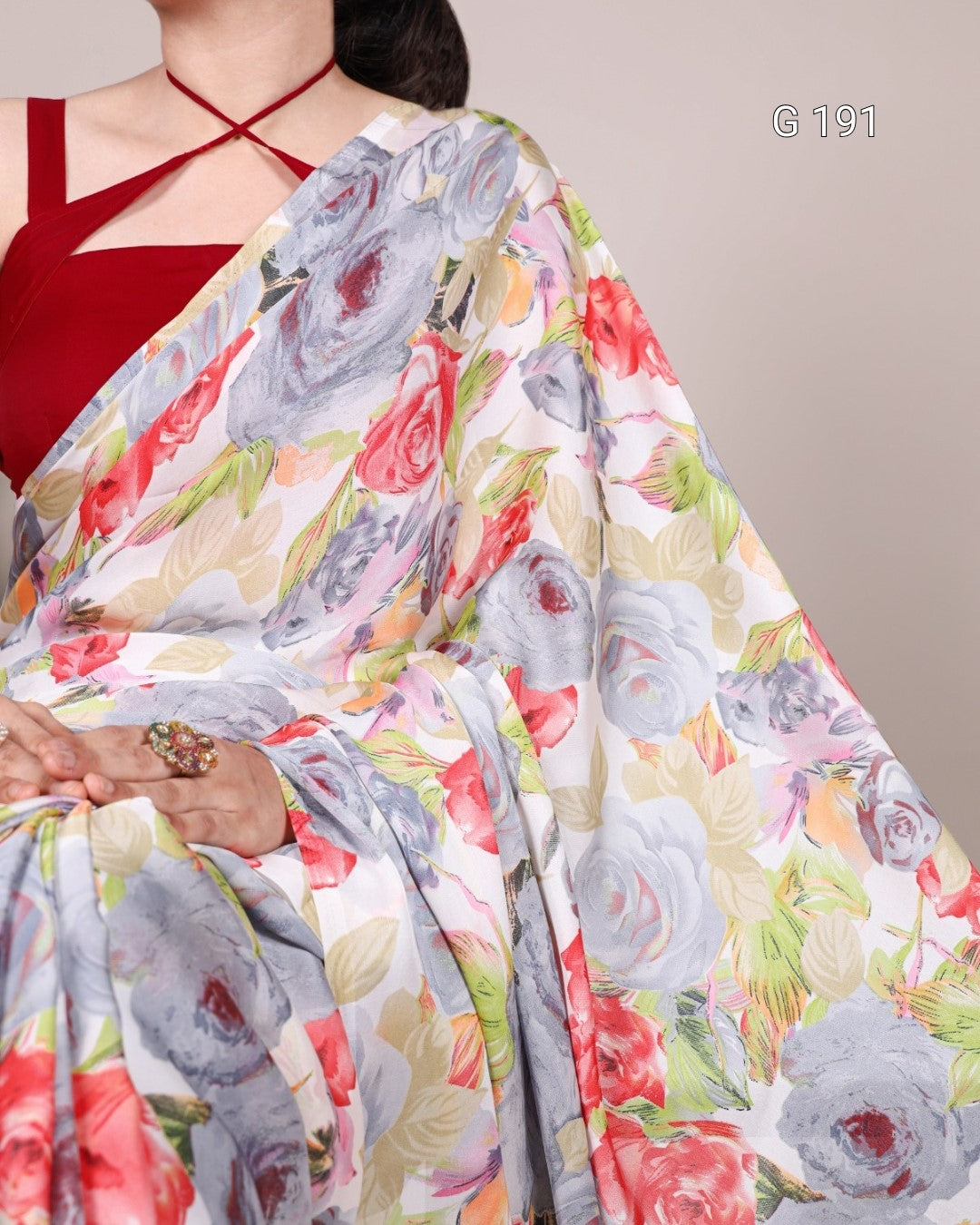 Floral saree with a red blouse on a neutral background