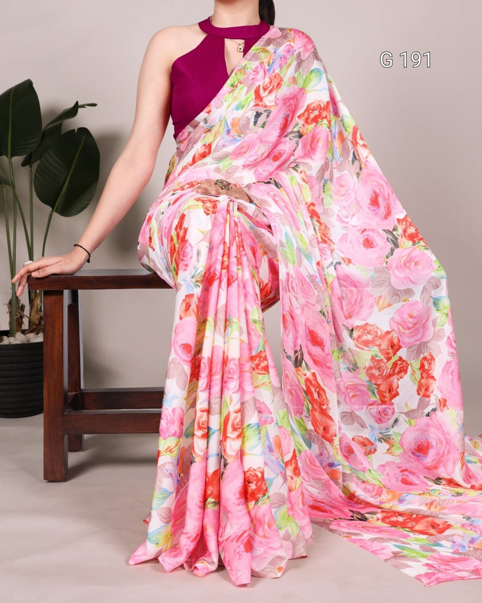 Woman wearing a colorful floral saree with a plain background