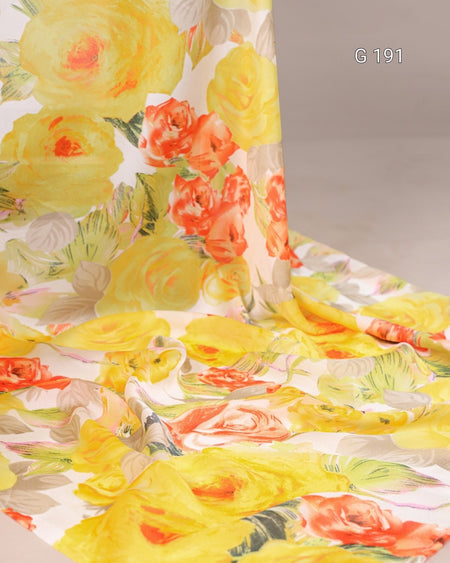 Floral fabric with yellow, orange, and pink flowers on a plain background