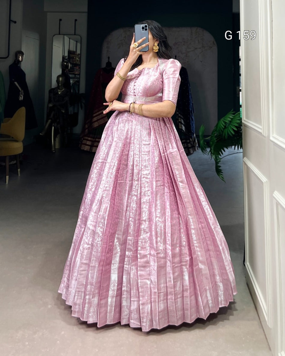Person wearing a pink dress taking a mirror selfie in an indoor setting.
