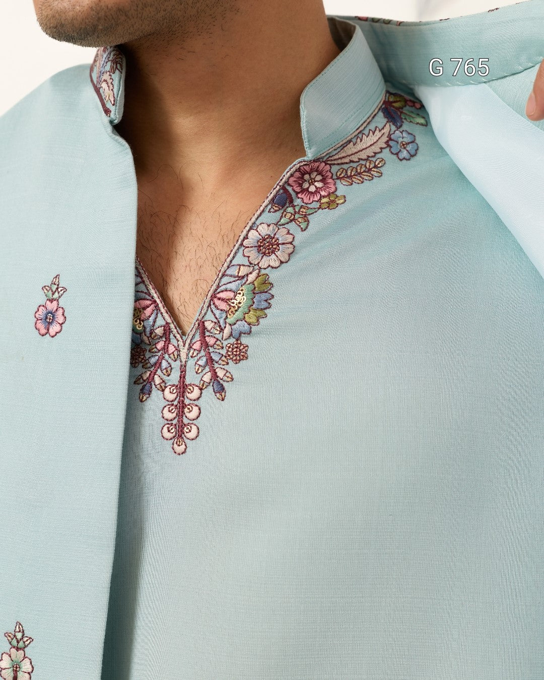 Light blue shirt with intricate floral embroidery on a blurred background