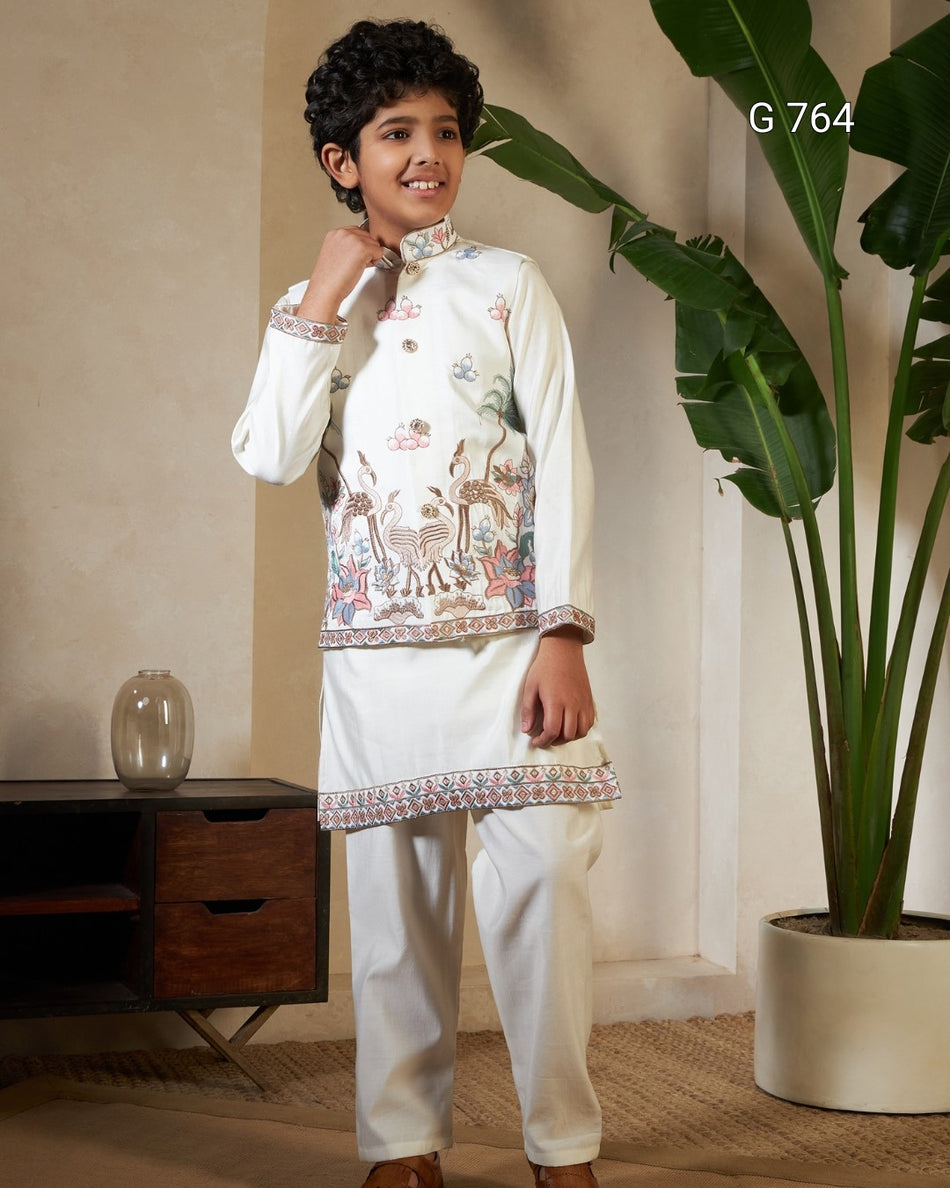 Young boy in traditional embroidered outfit standing indoors with a plant in the background